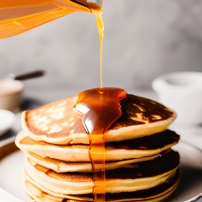 maple syrup poured over pancakes